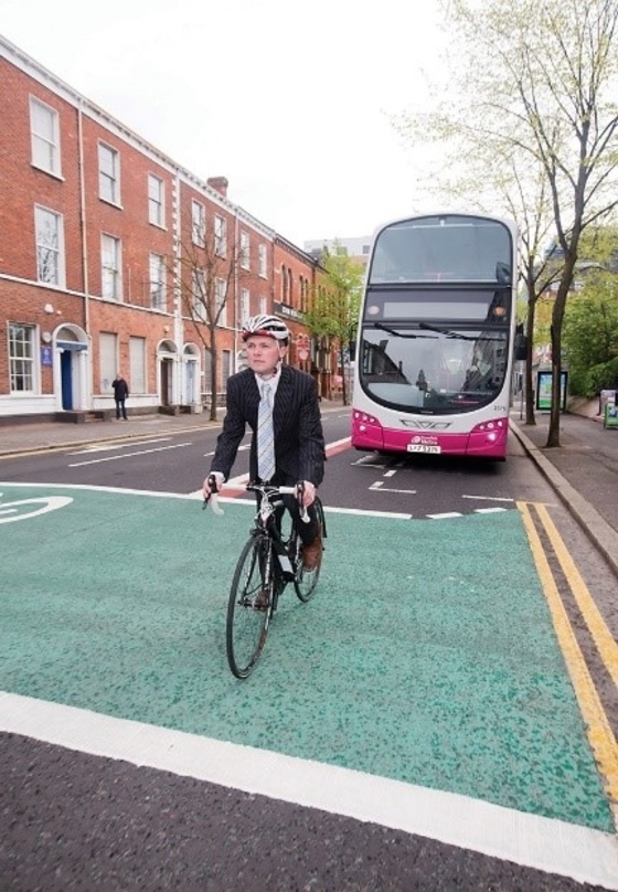 Cyclist infront of bus